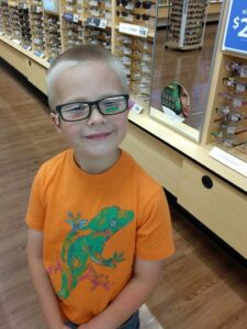 Happy boy with his favorite color on his glasses!