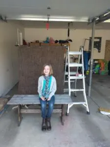 My daughter demonstrating my set-up in the messy garage.