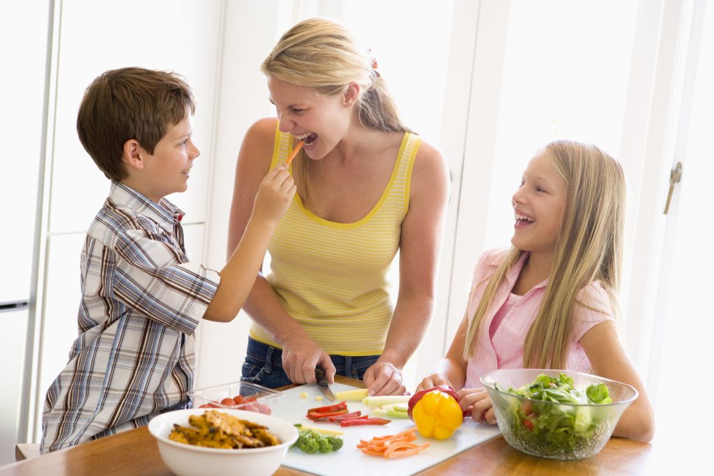 Woman cooking at home with kids to save money