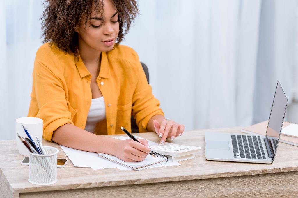 Woman at computer with notebook