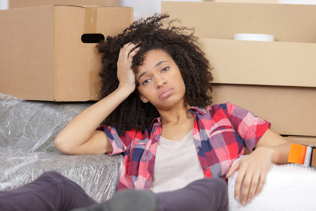 Tired woman surrounded by boxes