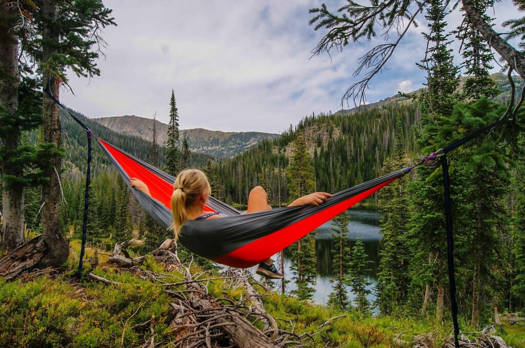 Women enjoying a cheaper alternative to eno hammock by a mountain stream.