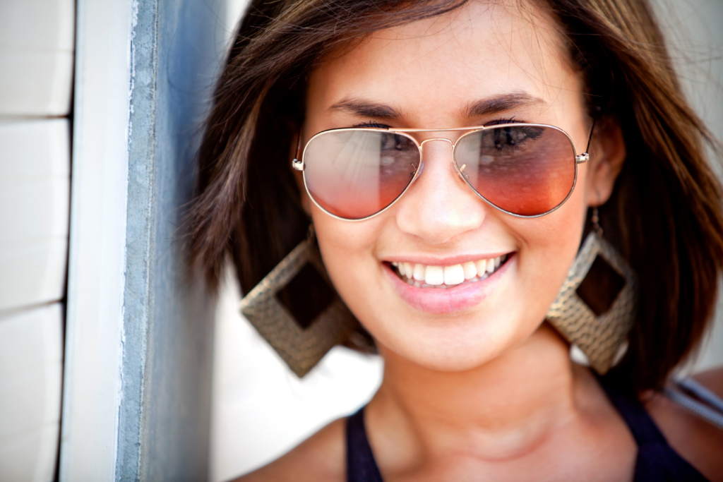 Woman smiling wearing sunglasses