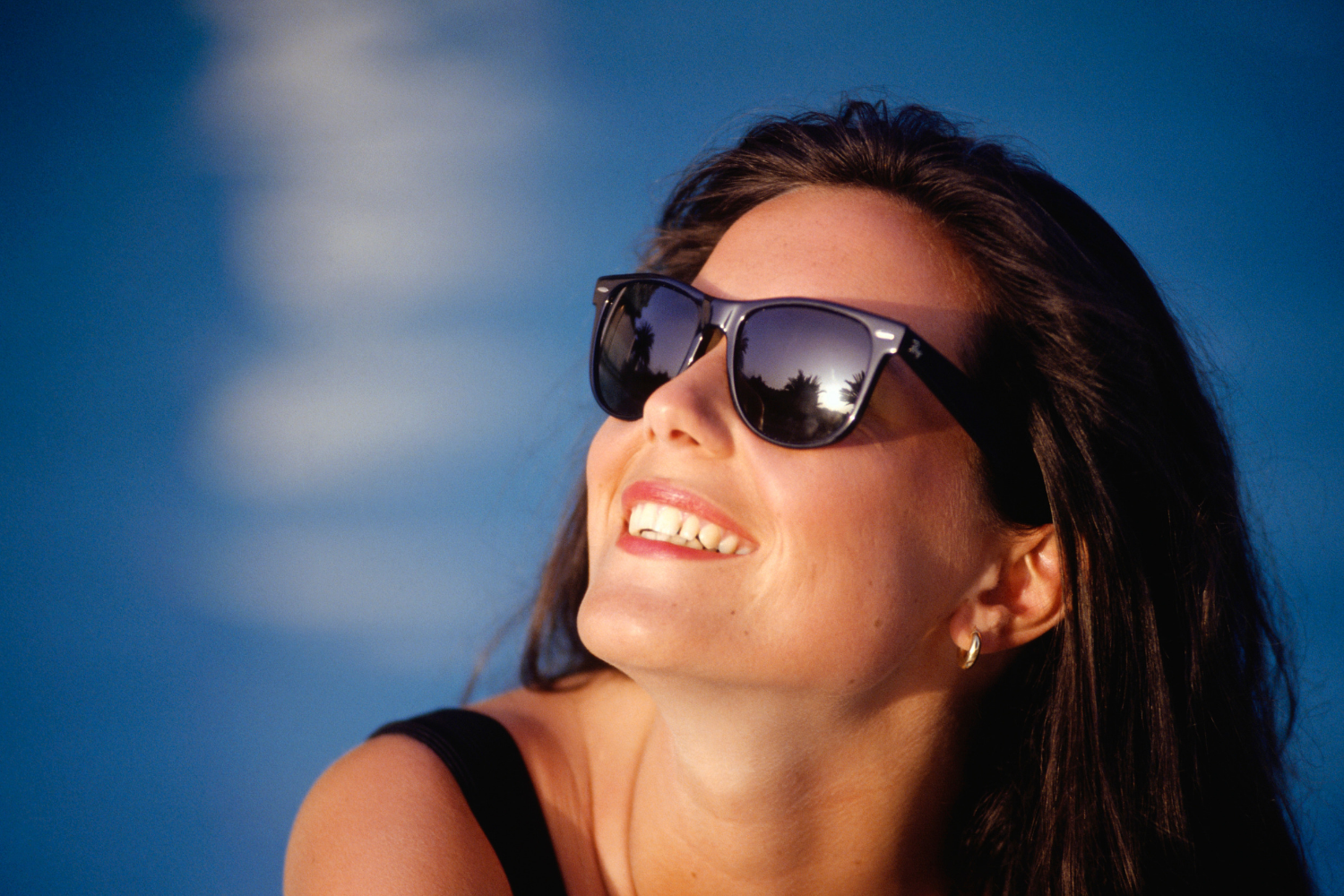 Lady smiling wearing cheaper sunglasses