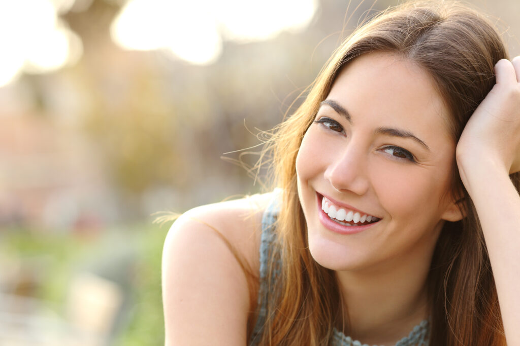 Young woman smiling in park