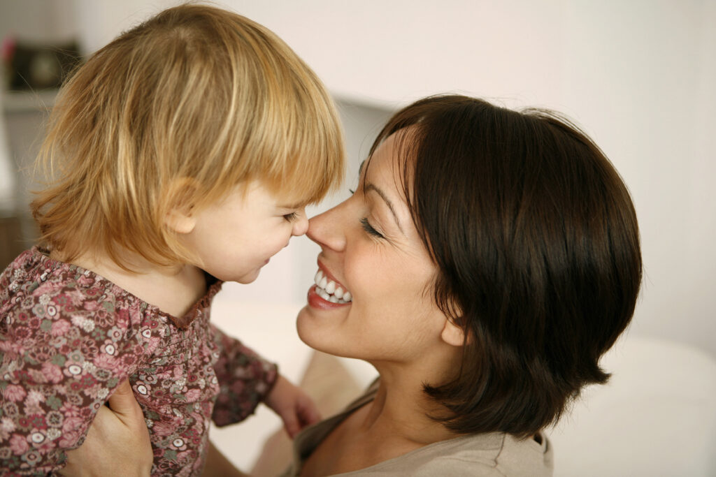 Mother and child smiling at each other