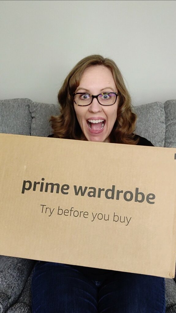 Woman smiling holding a Amazon Prime Wardrobe box