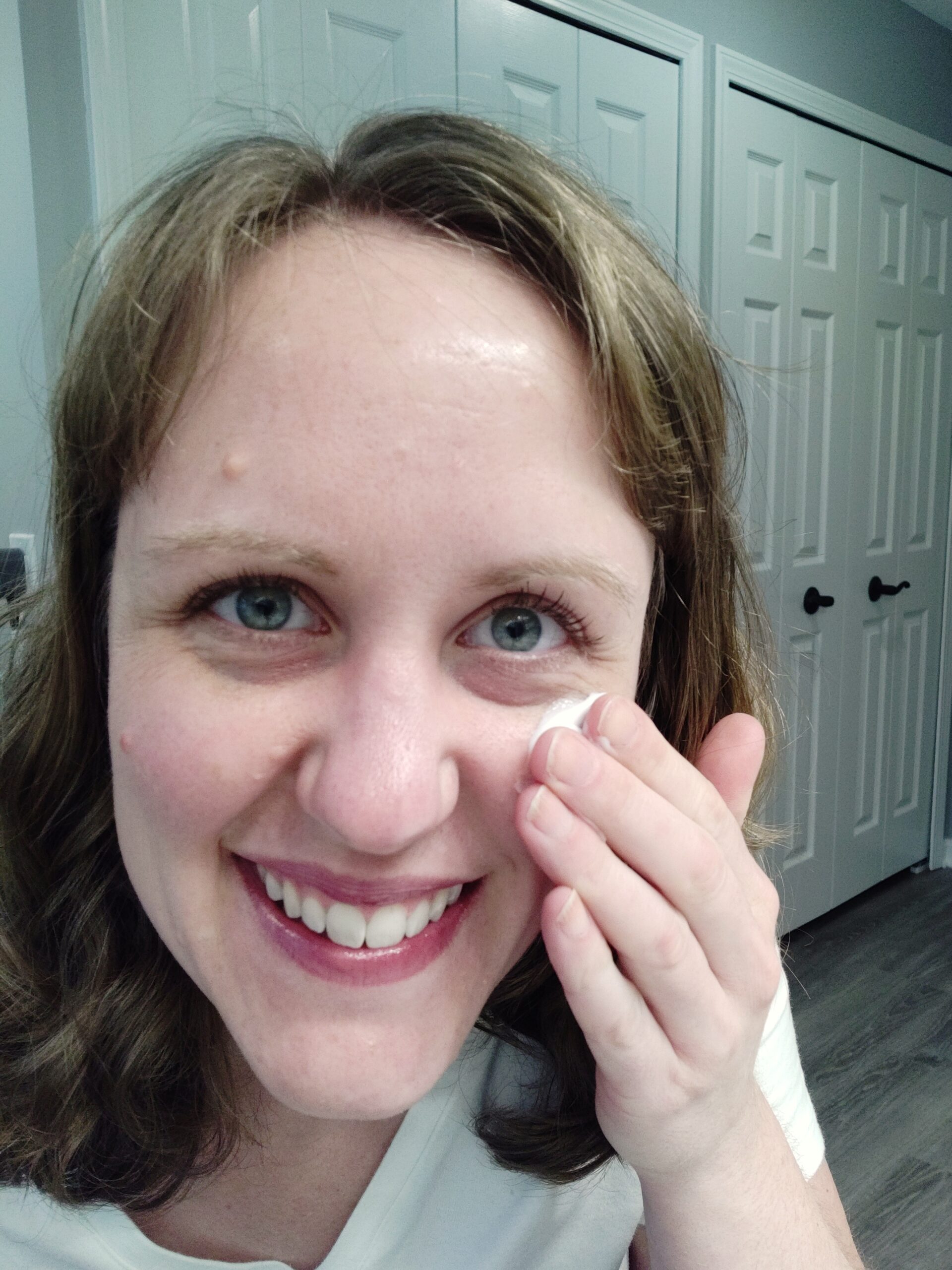 Woman putting moisturizer on her face