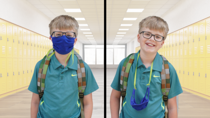 Boy wearing a face mask on his face and boy wearing same mask around his neck