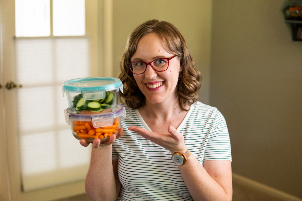 Woman holding Snapware glass food storage containers