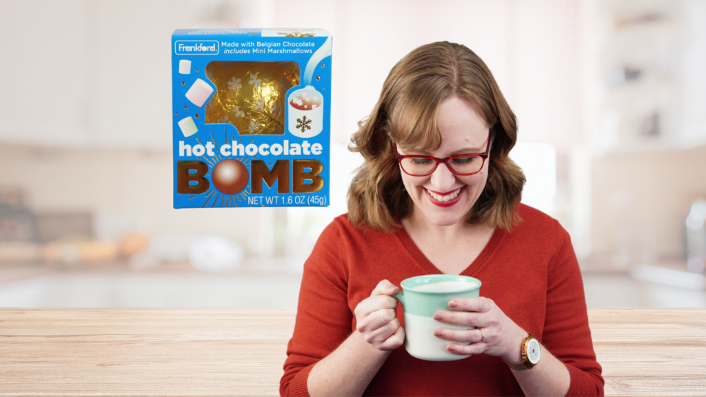 hot chocolate bomb and woman smiling at mug